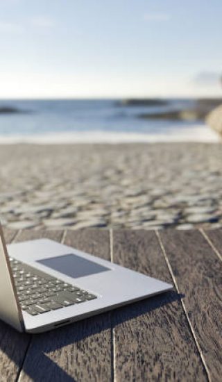 Laptop and sea, workplace on beach. Distance work, working online. Education, courses, online training and learning. Shopping via internet. E-commerce. Vacation, holiday and work. Freelance. 3D render